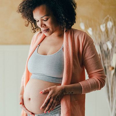 Pregnant woman holding bump